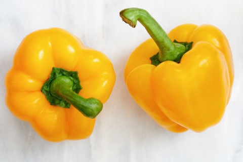 Studio shot of two yellow bell peppers
