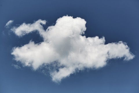 Single white cloud in blue sky