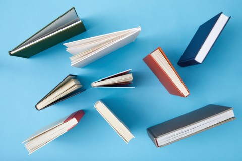Overhead view of books on blue background