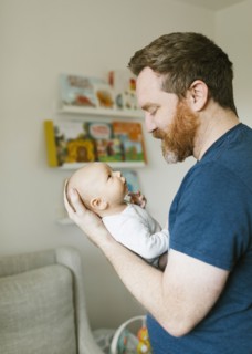 Father holding newborn son