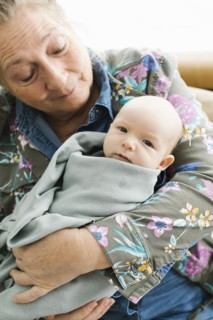 Grandmother holding newborn grandson