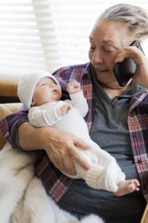 Grandmother holding newborn grandson