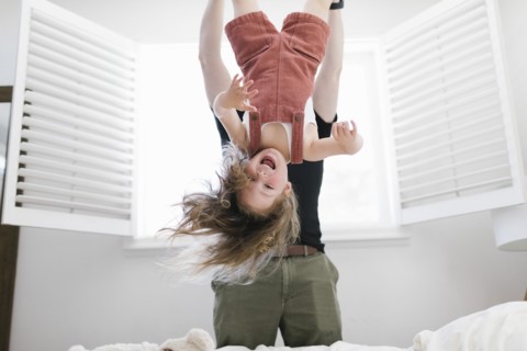 Father swinging daughter