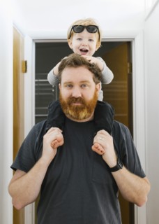 Portrait of father carrying son