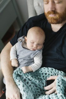 Father sleeping with newborn son