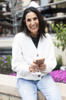 Portrait of smiling woman using phone