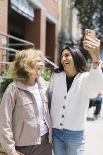 Smiling female friends taking selfie
