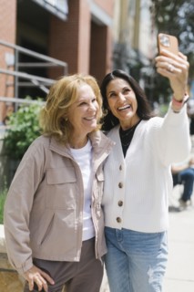 Smiling female friends taking selfie
