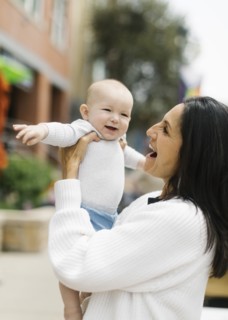 Grandmother holding baby grandson