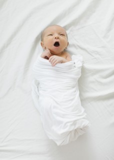Swaddled newborn boy