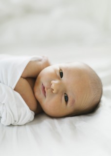 Portrait of swaddled newborn boy