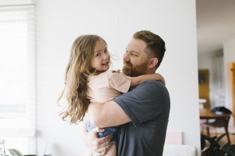 Father holding daughter