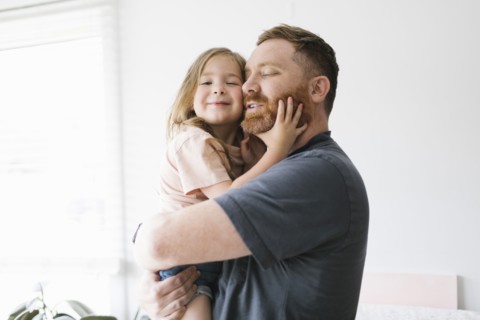 Father holding daughter