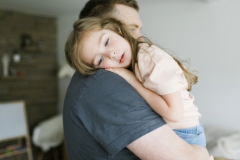 Father holding daughter