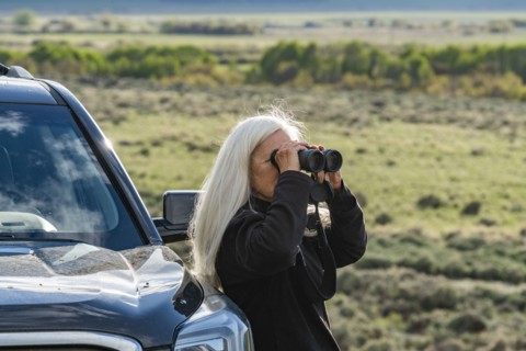 Senior woman using binoculars