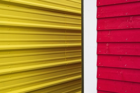 Close-up of yellow and red building walls