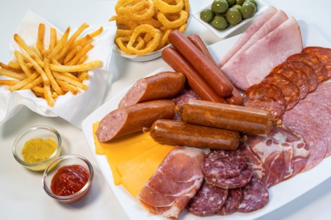 Assorted unhealthy processed and fried foods on table