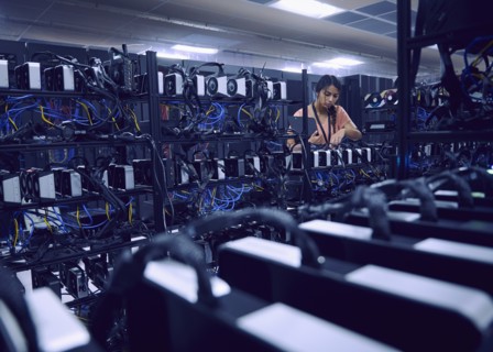 Female technician working in server room