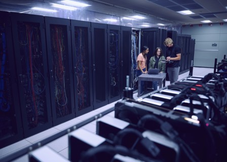 Team of technicians working in server room
