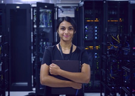 Portrait of smiling female technician in server room