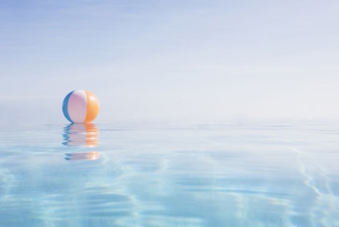 Beach ball floating on water surface