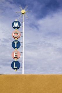 Vintage motel sign against sky