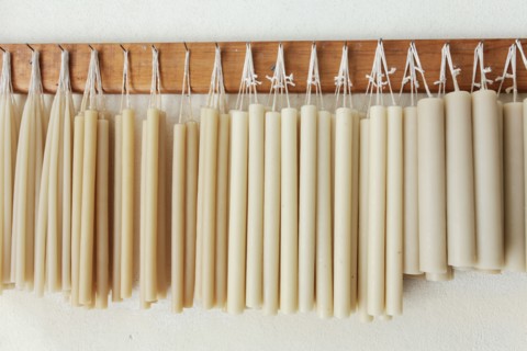Hand-made candles hanging on wall