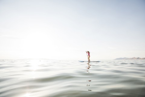 Woman paddleboarding on lake