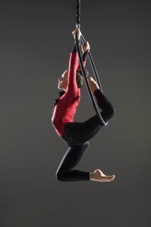 Young acrobat performing on aerial hoop