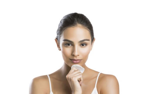 Portrait of young woman holding cotton pad