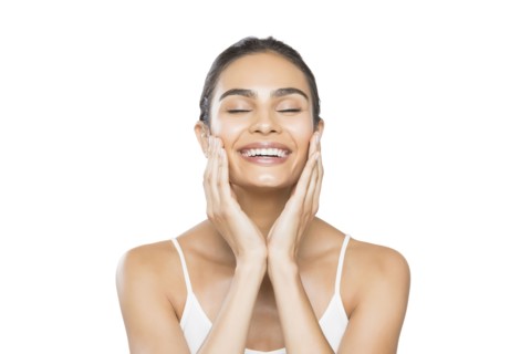 Portrait of young woman with closed eyes doing facial massage