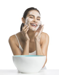 Portrait of young woman enjoying washing face