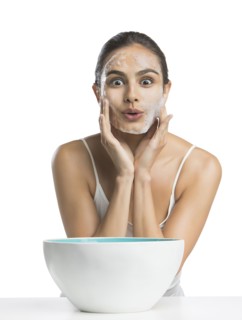 Portrait of young woman enjoying washing face
