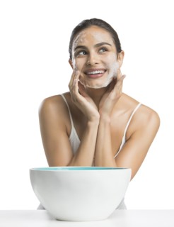 Portrait of young woman enjoying washing face