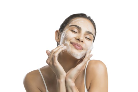 Portrait of young woman enjoying washing face