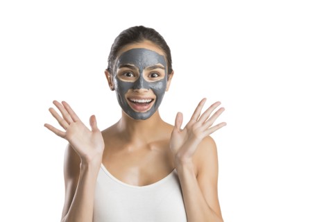 Portrait of young woman with facial beauty mask