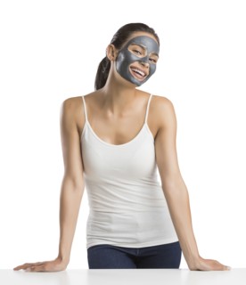 Portrait of young woman with facial beauty mask