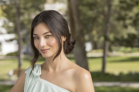 Portrait of beautiful woman looking at camera in park