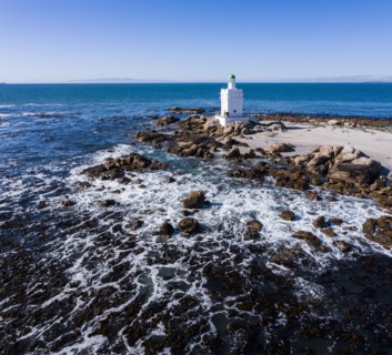 White lighthouse on coast of Atlantic Ocean