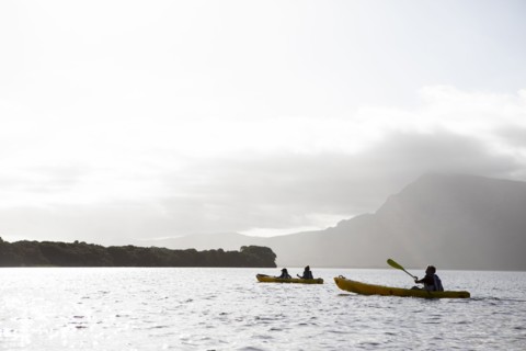 Kayakers kayaking in lagoon
