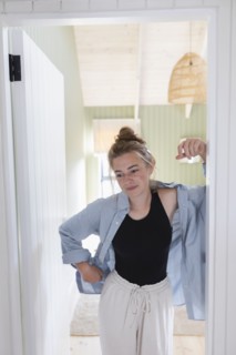 Teenage girl standing in doorway