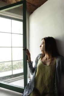 Young woman looking out window