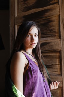 Portrait of young woman in doorway