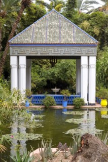 Moroccan tiles roof atop gazebo by tranquil pond