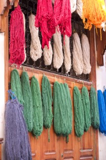 Colorful yarn hanging to dry after being dyed
