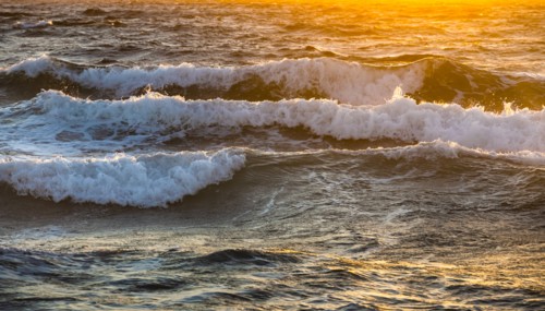 Close-up of sea waves reflecting sunlight