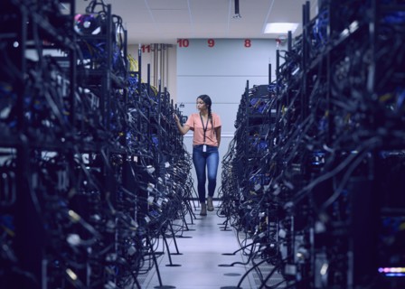 Female technician working in server room