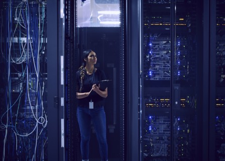 Female technician working in server room