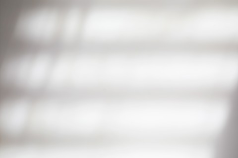 Shadows of blinds on white wall