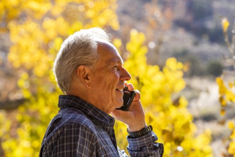 Senior man with smartphone in Zion National Park
